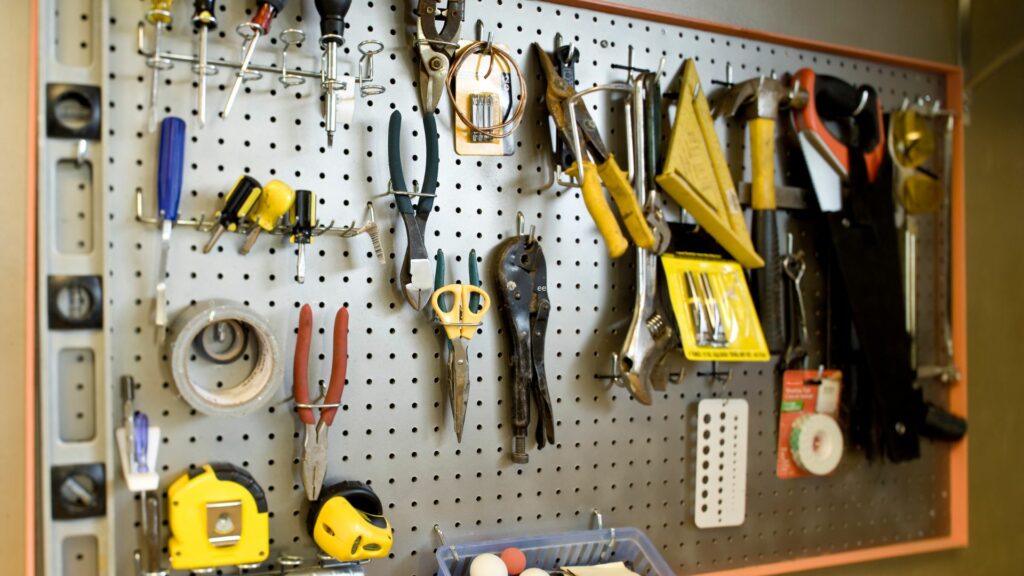 A pegboard with tools used for garage organization 