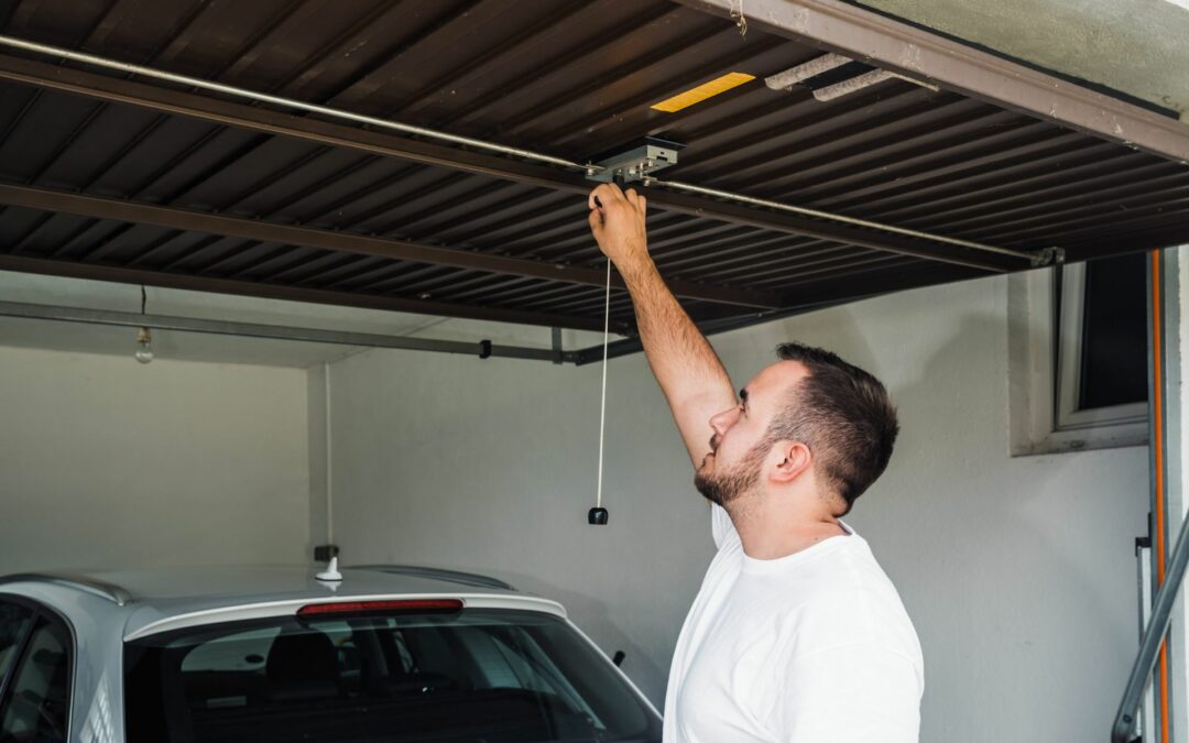 A homeowner performing garage door maintenance