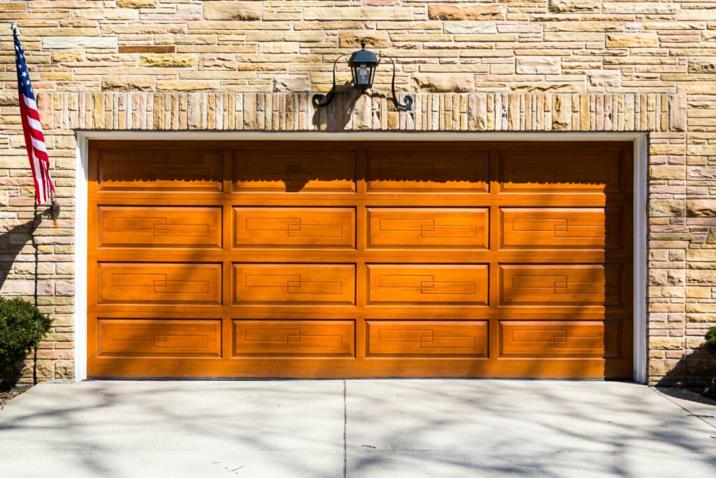 A garage door that closely resembles oak, making it an excellent example of faux wood garage doors