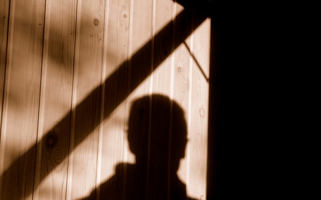 A burglar's shadow on a garage, a sign that garage security is being compromised
