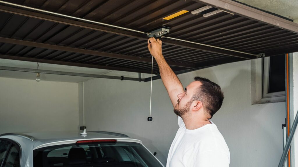 A homeowner who is examining his garage door and deciding that he needs professional garage door services