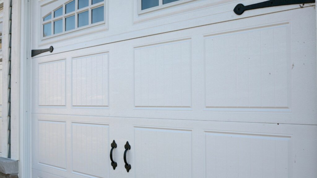 Two white vinyl garage doors 